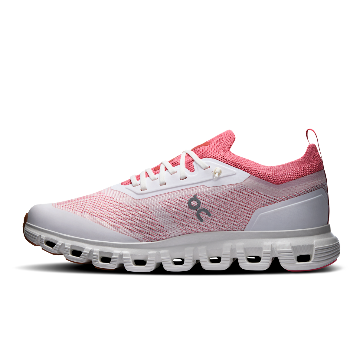 Women's running shoes with pink knit upper, white laces, gray cushioned sole