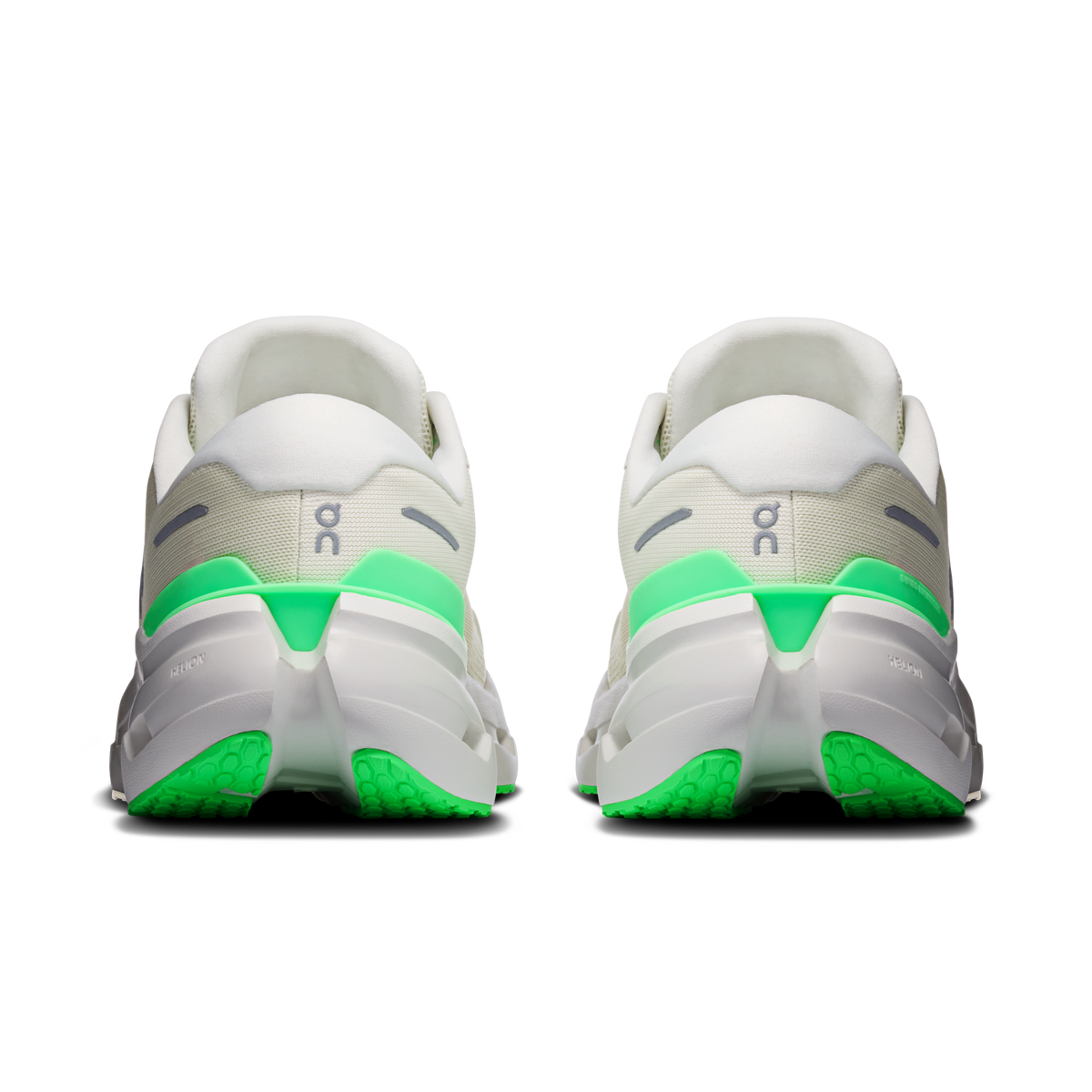 Back view of wide running shoes with green heel panels and cushioned white sole