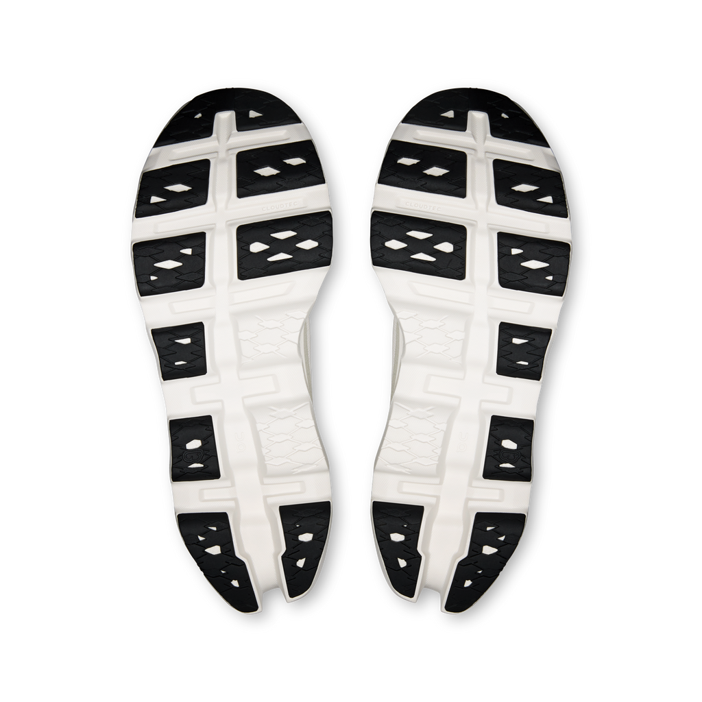 Ivory shoe outsole with tread pods and black grip sections