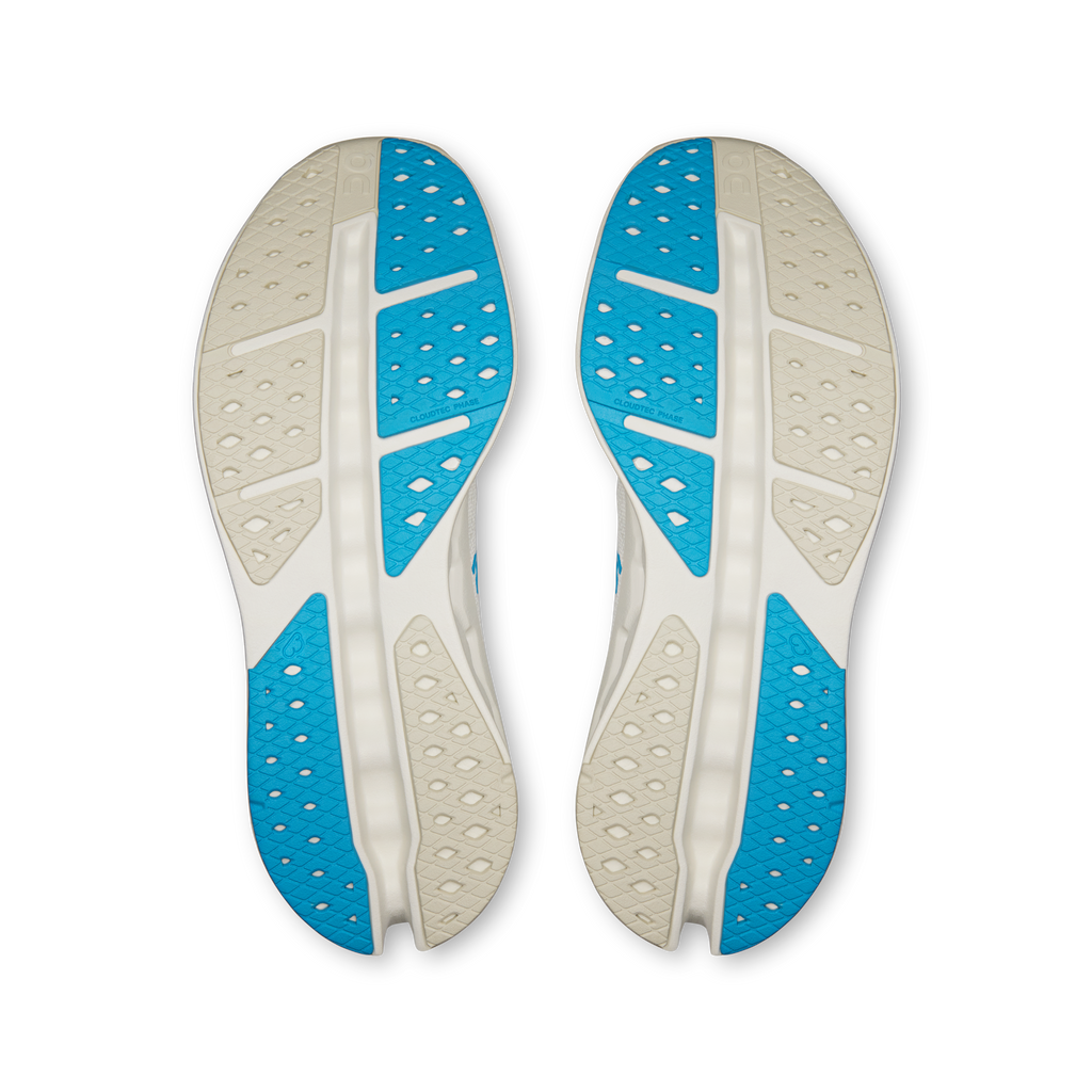Shoe outsoles view: white and blue tread with perforated traction pattern