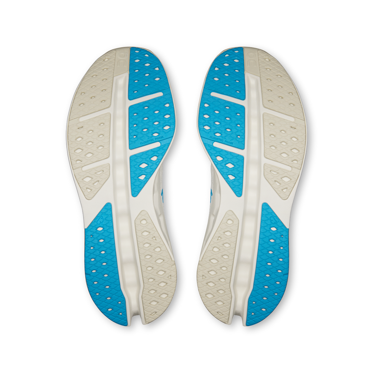 Shoe outsoles view: white and blue tread with perforated traction pattern