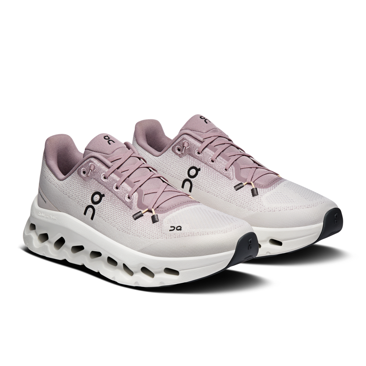 Pair of women’s On running shoes in light mauve with white perforated cushioning sole