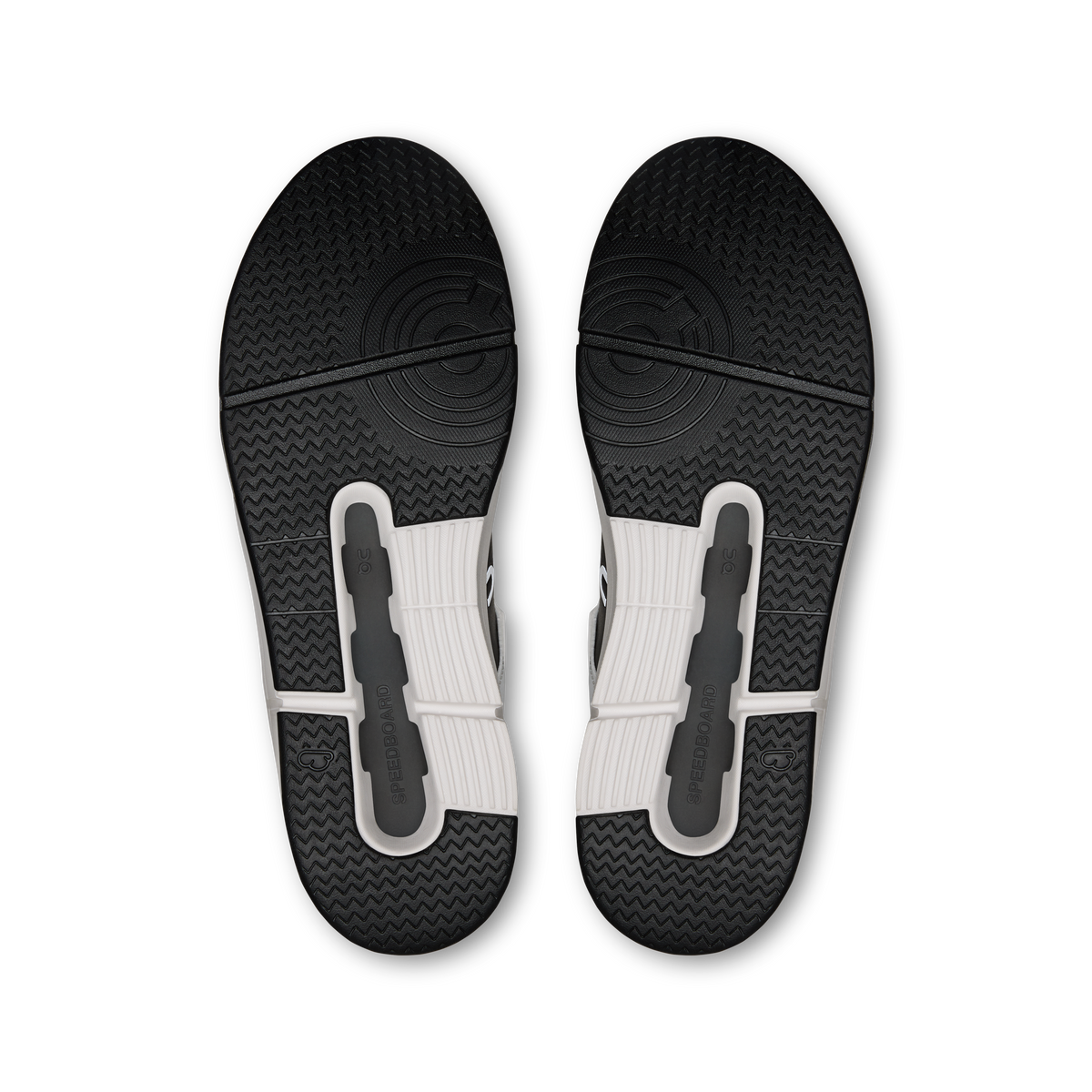 Pair of dark rubber sneaker outsoles with textured tread and molded traction pods