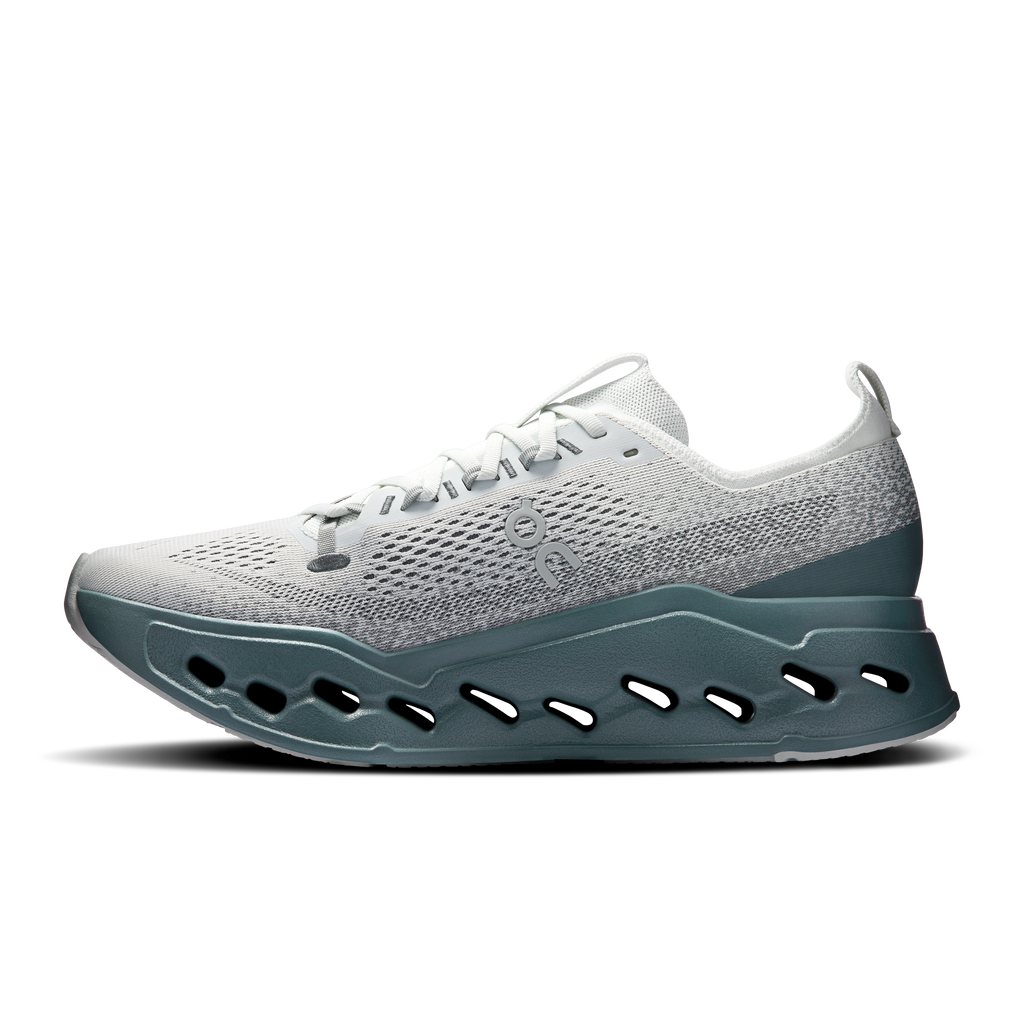 Light gray lace-up running shoe with teal outsole pods and cushioned sidewall