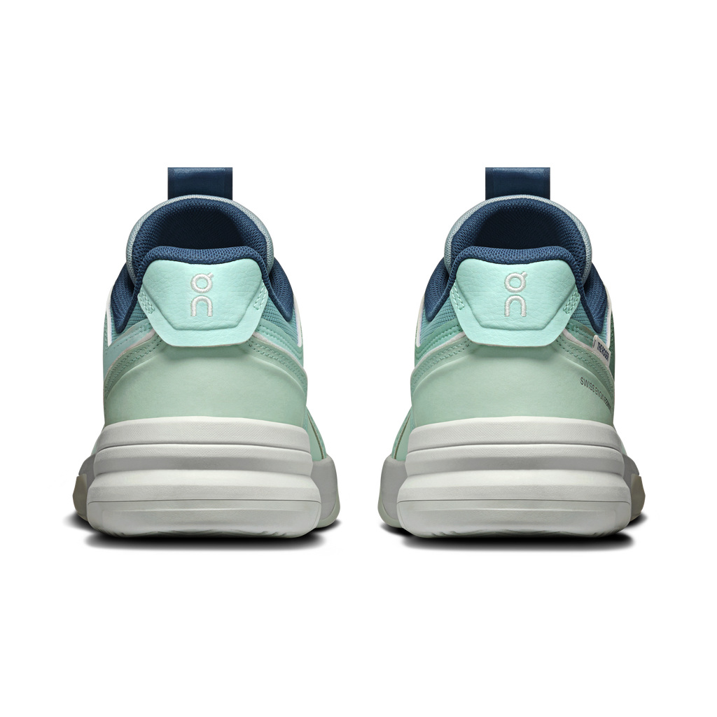 Women's mint and blue running shoes, heel view with ribbed midsole stripes