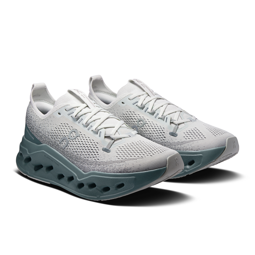 Pair of light gray lace-up running shoes with teal and dark gray outsole pods