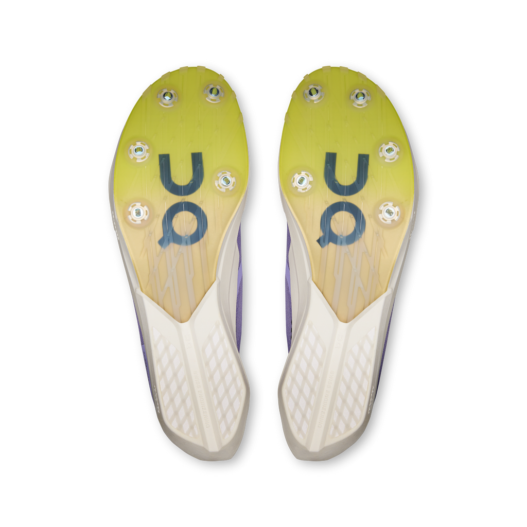 Pair of shoe outsoles in yellow with grip studs and On logo markings
