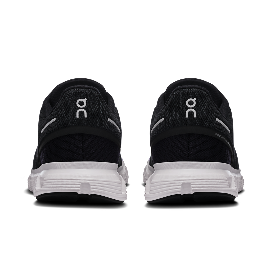 Women’s black running shoes, rear view with white midsole and cushioned heel collar