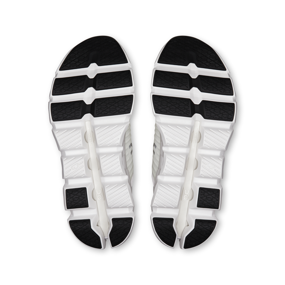 Pair of white shoe outsoles with black tread segments and CloudTec midsole