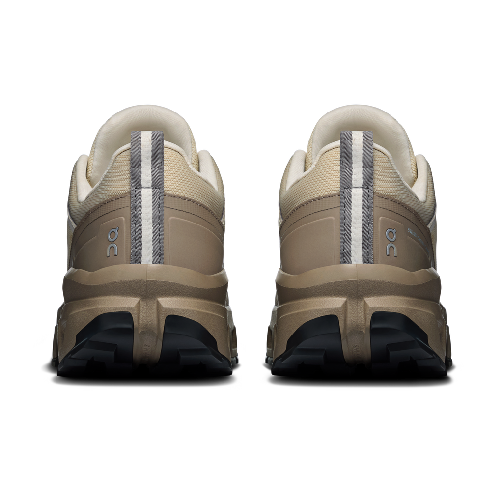 Women's waterproof low-top shoes, rear view with cream uppers and dark heel tread