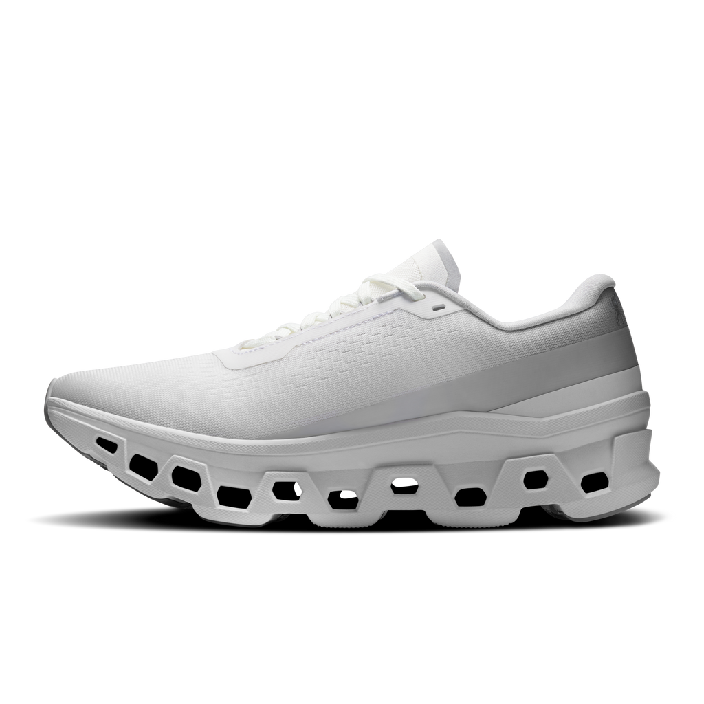 White women's running shoes, lateral side with thick CloudTec midsole and laces