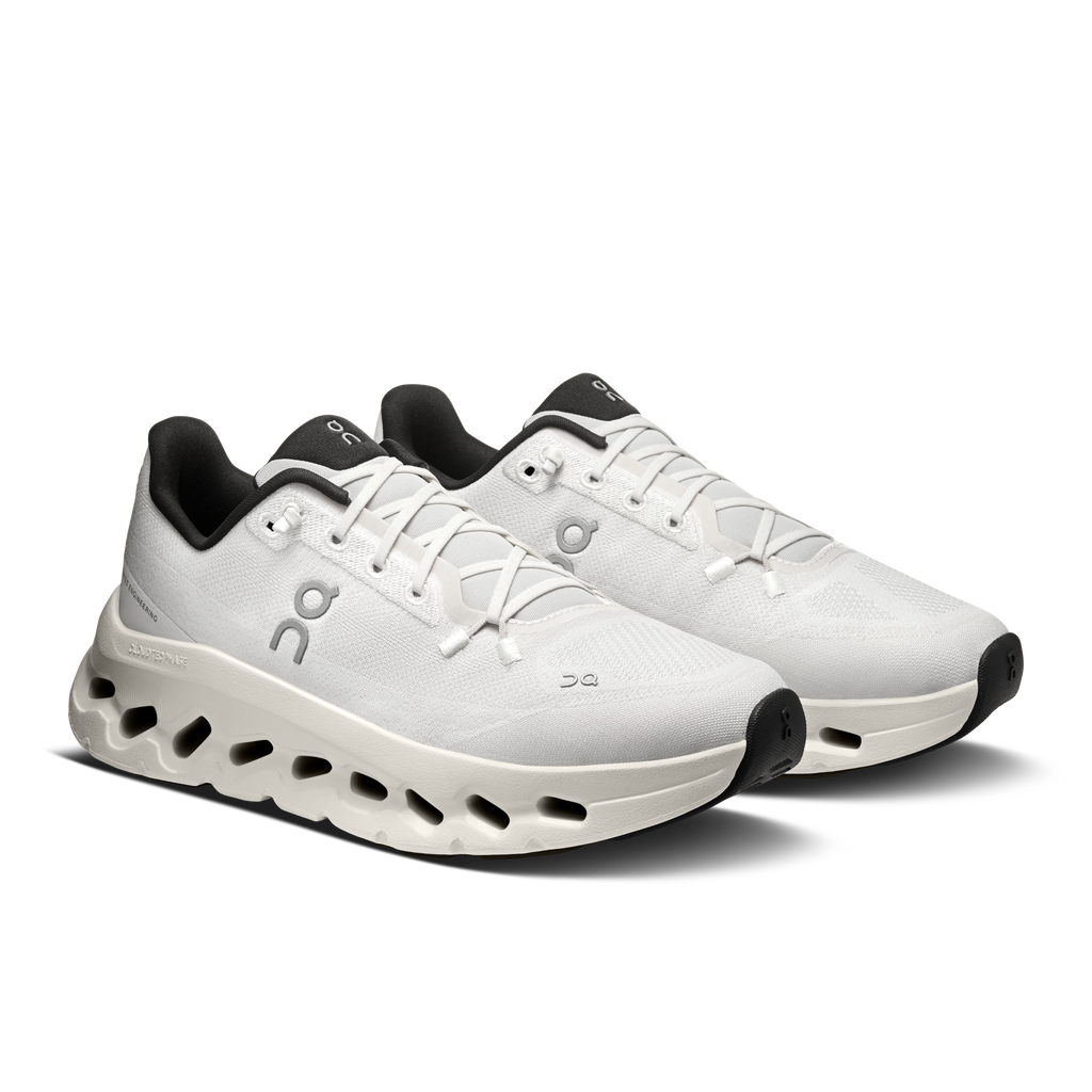 Women's running shoes with white upper, black heel accents, and CloudTec sole