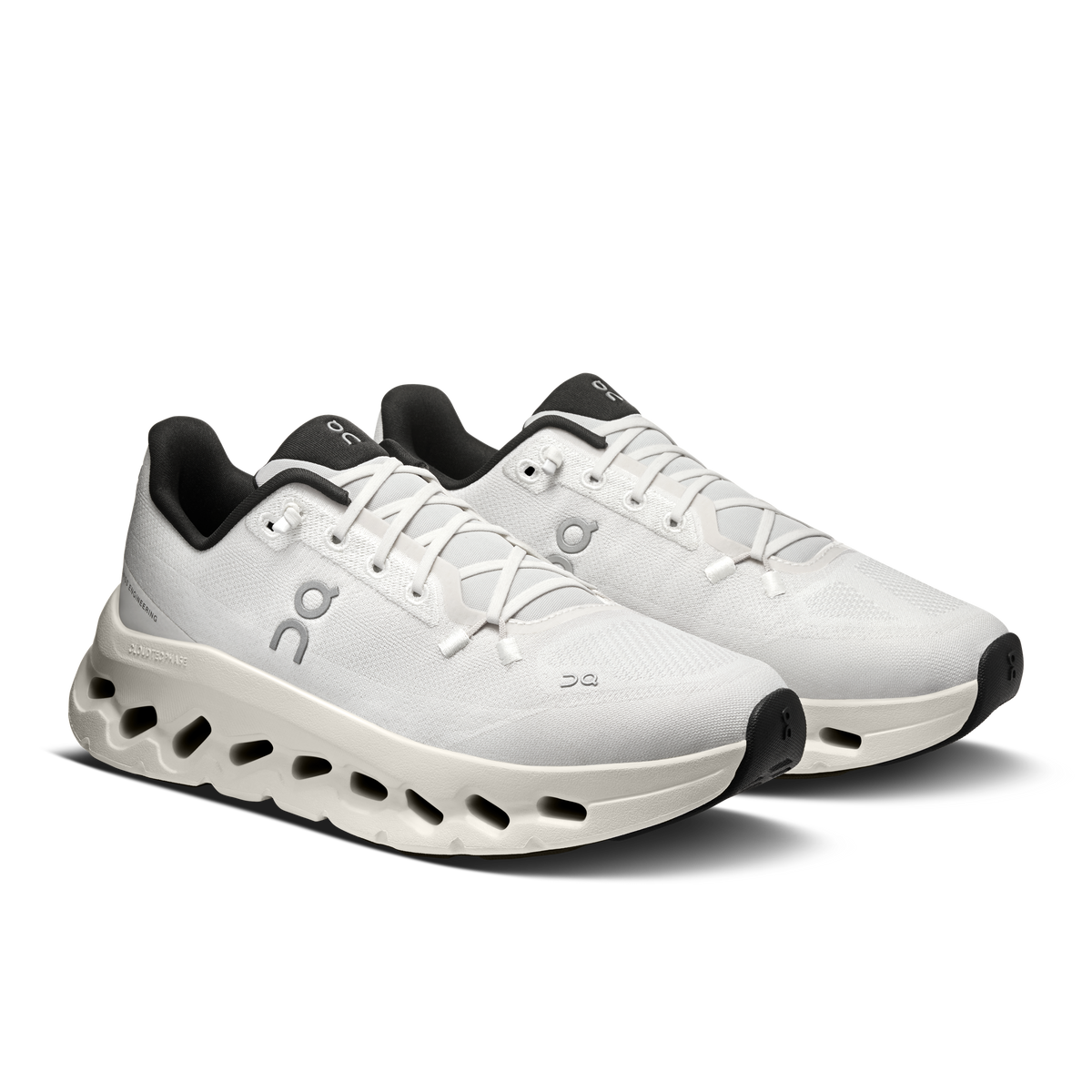 Women's running shoes with white upper, black heel accents, and CloudTec sole