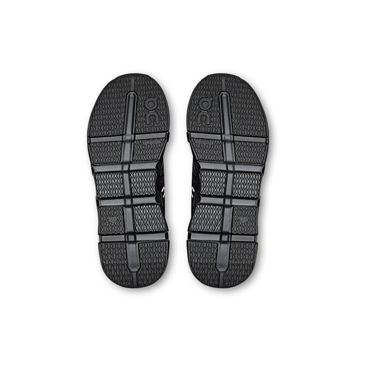 Kids' black shoe outsoles with grid tread and On logo heel sections