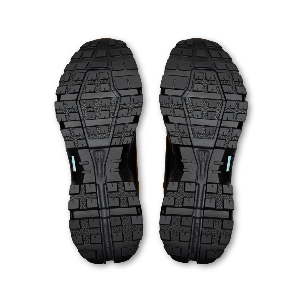 Pair of men’s mid waterproof hiking shoe outsoles with deep traction tread pattern