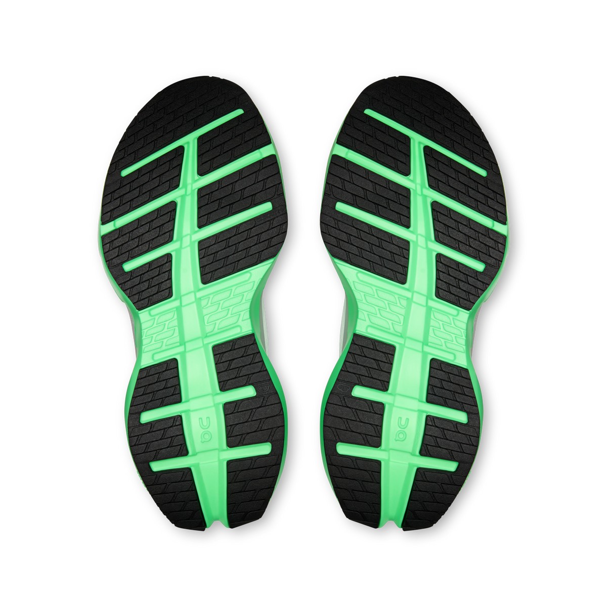 Shoe outsoles, black tread with bright mint-green grid channels