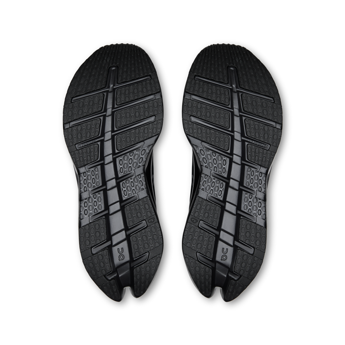 Pair of black shoe soles with patterned traction tread and On logo at heel