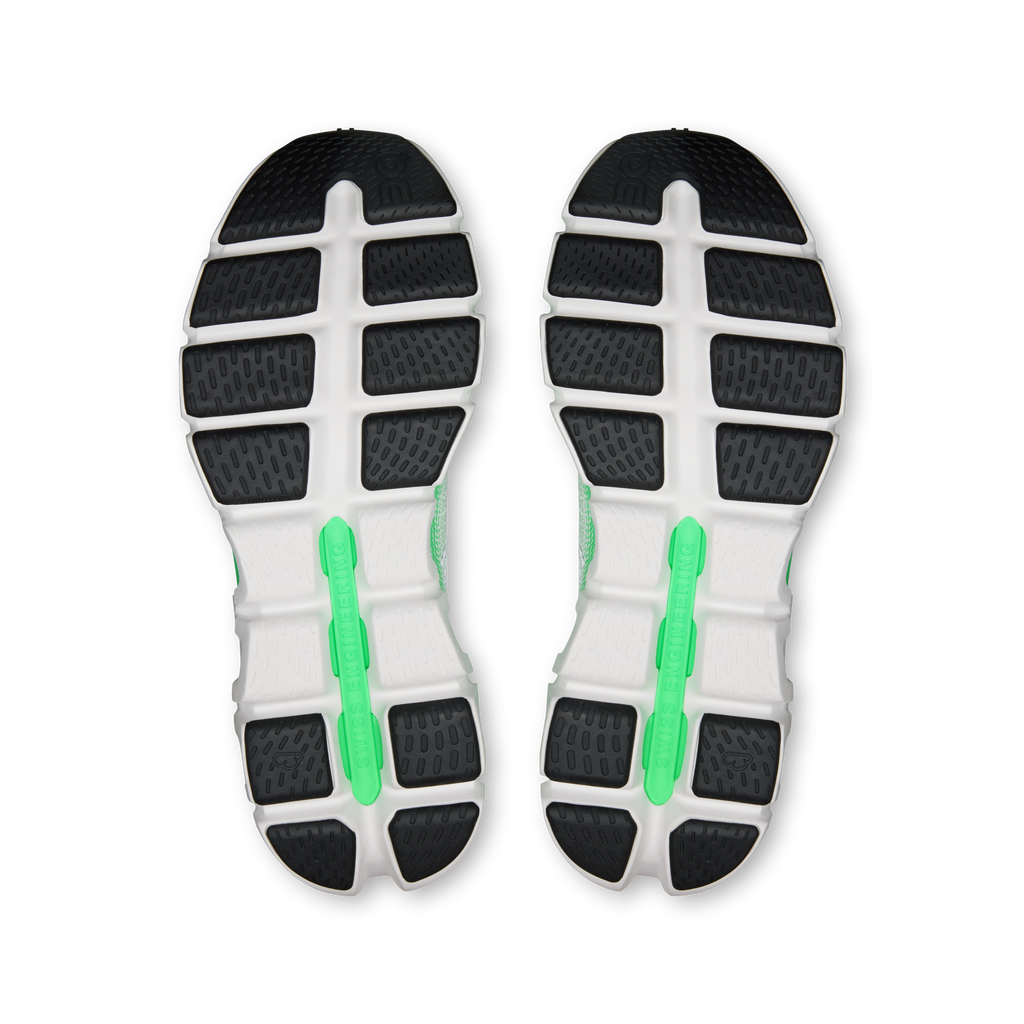 Men's running shoe outsole view with patterned rubber and green inserts