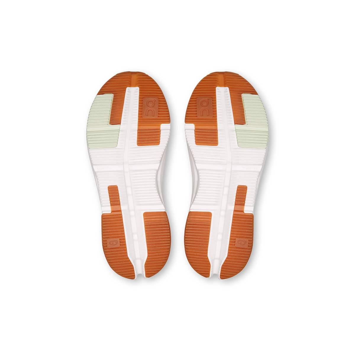 Kids' shoe outsole with orange traction pods and white tread pattern