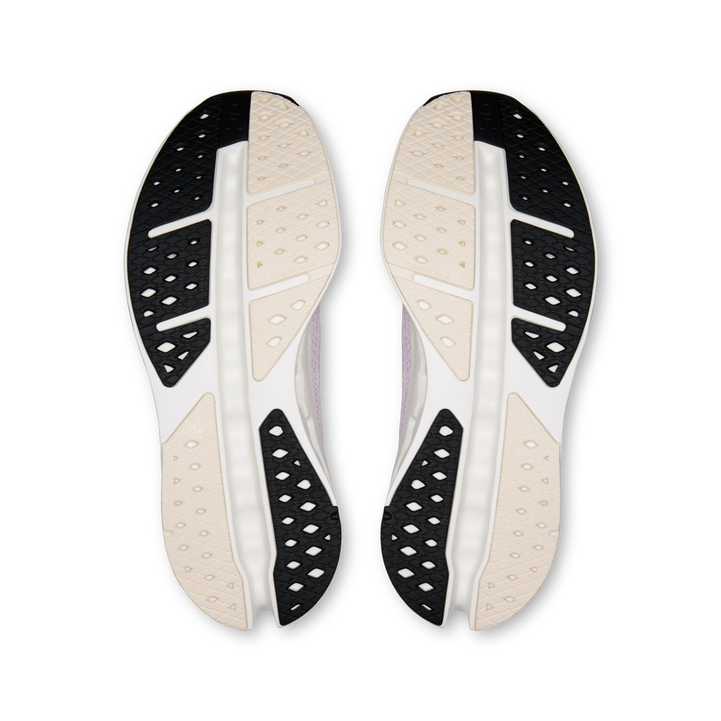 Shoe outsoles with black traction pods and light beige rubber panels