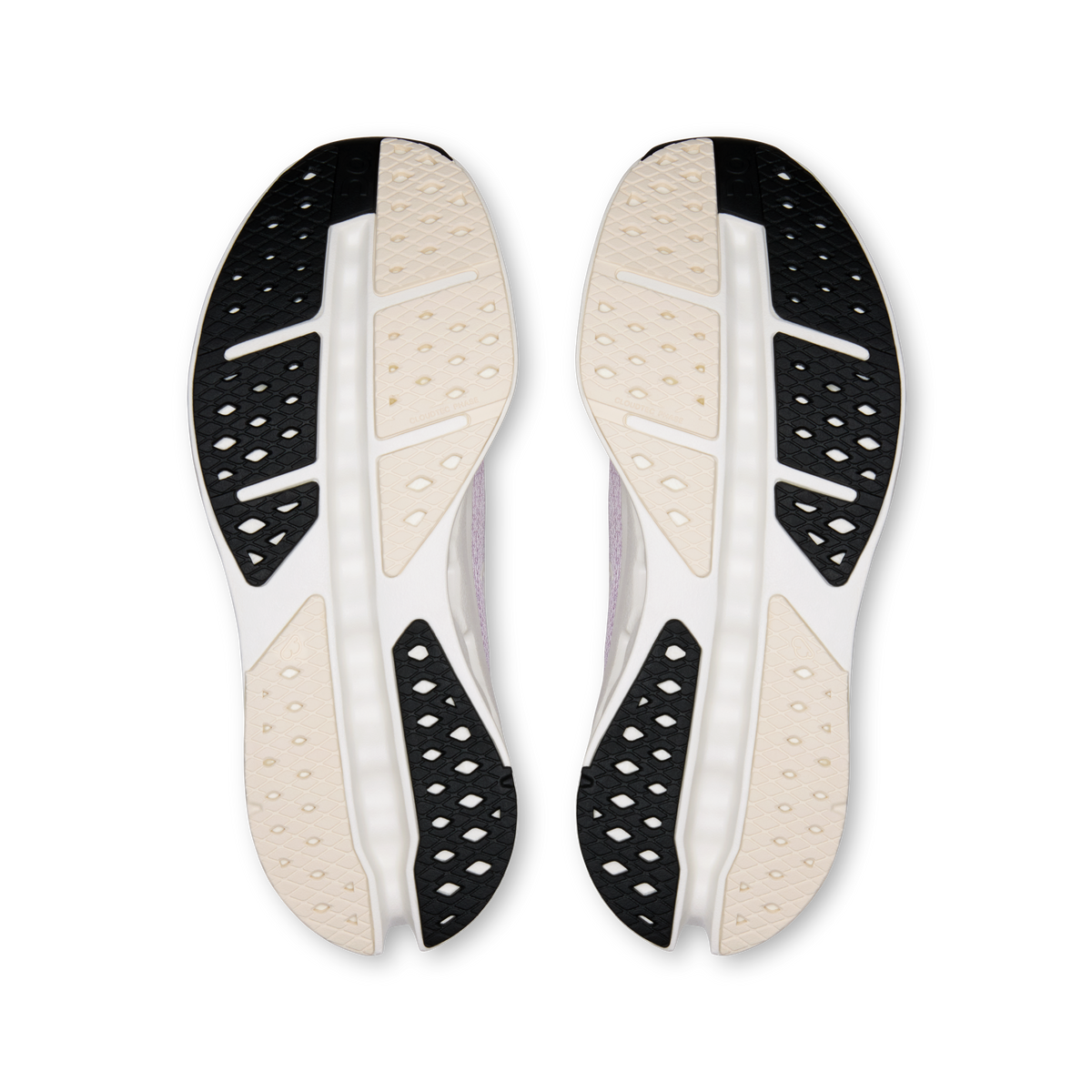 Shoe outsoles with black traction pods and light beige rubber panels