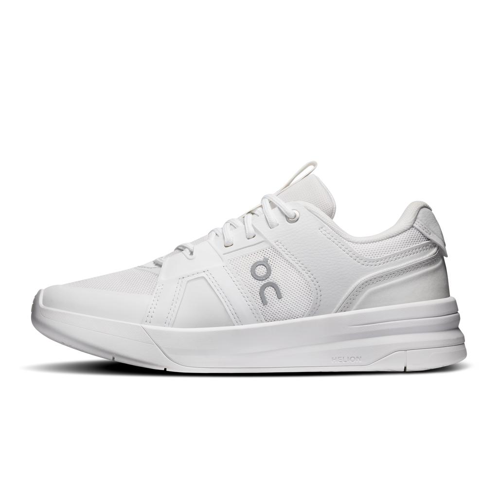 On women's running shoes in white with lace-up design and side logo near toe