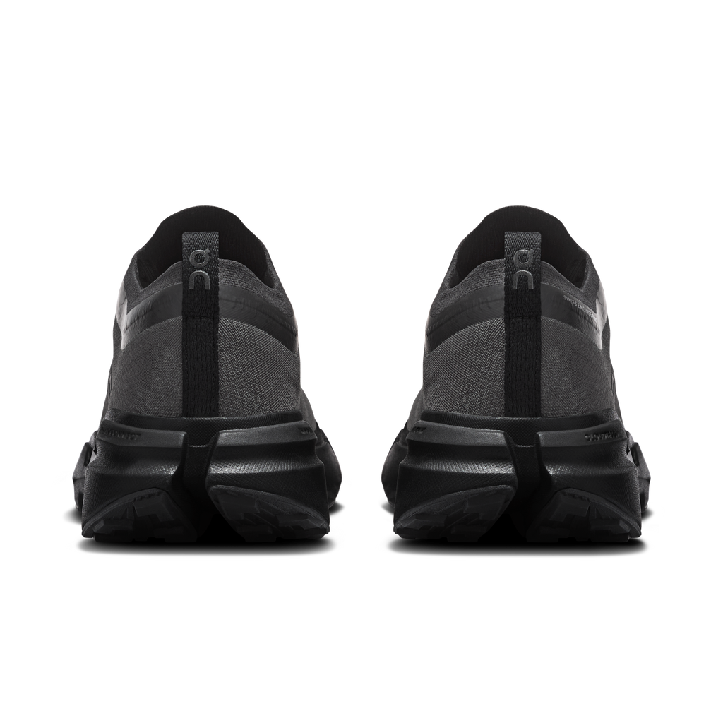 Women's black running shoes seen from heel with cushioned back and pull-tab