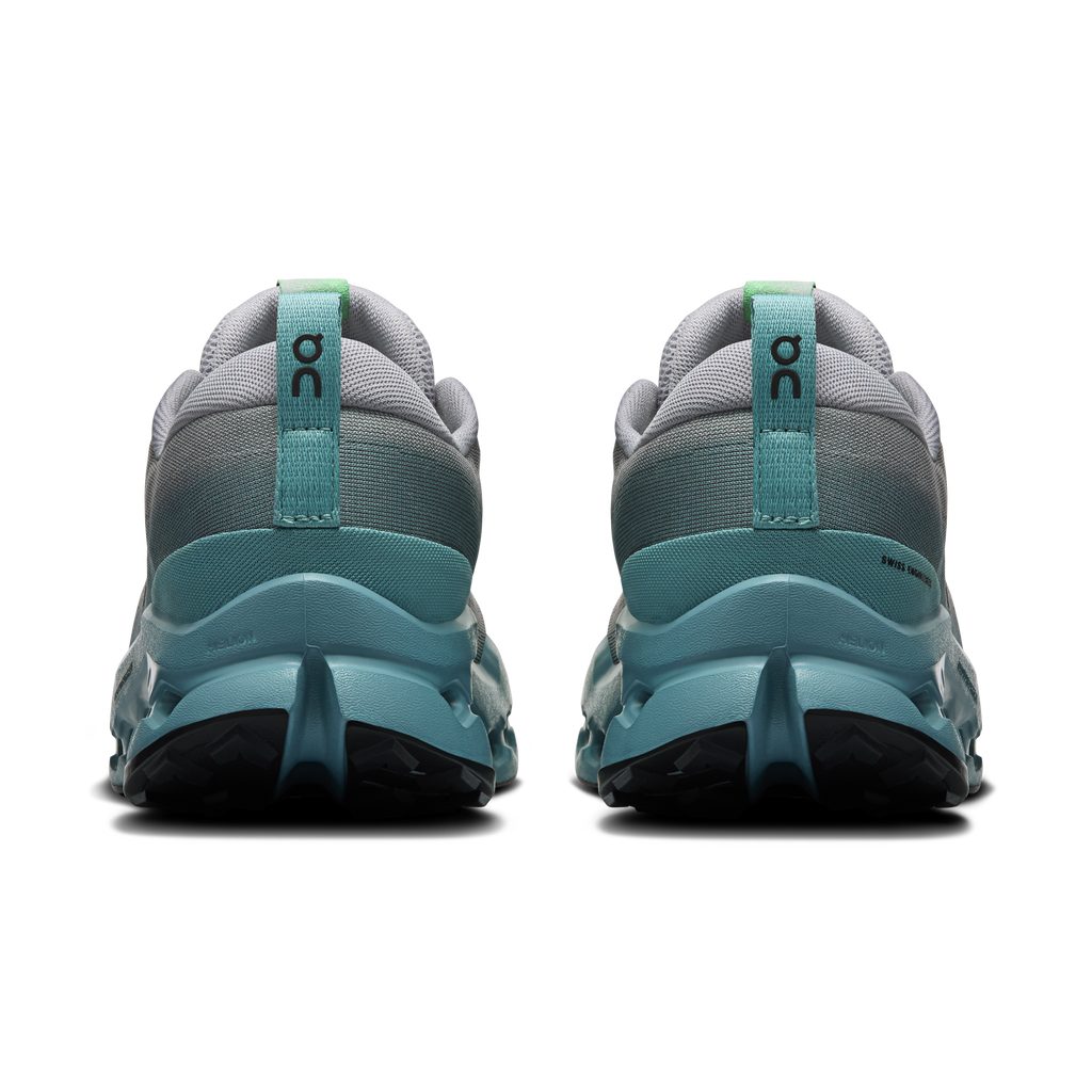 Men's trail running shoes heel view, light gray fabric with teal support and green logo.