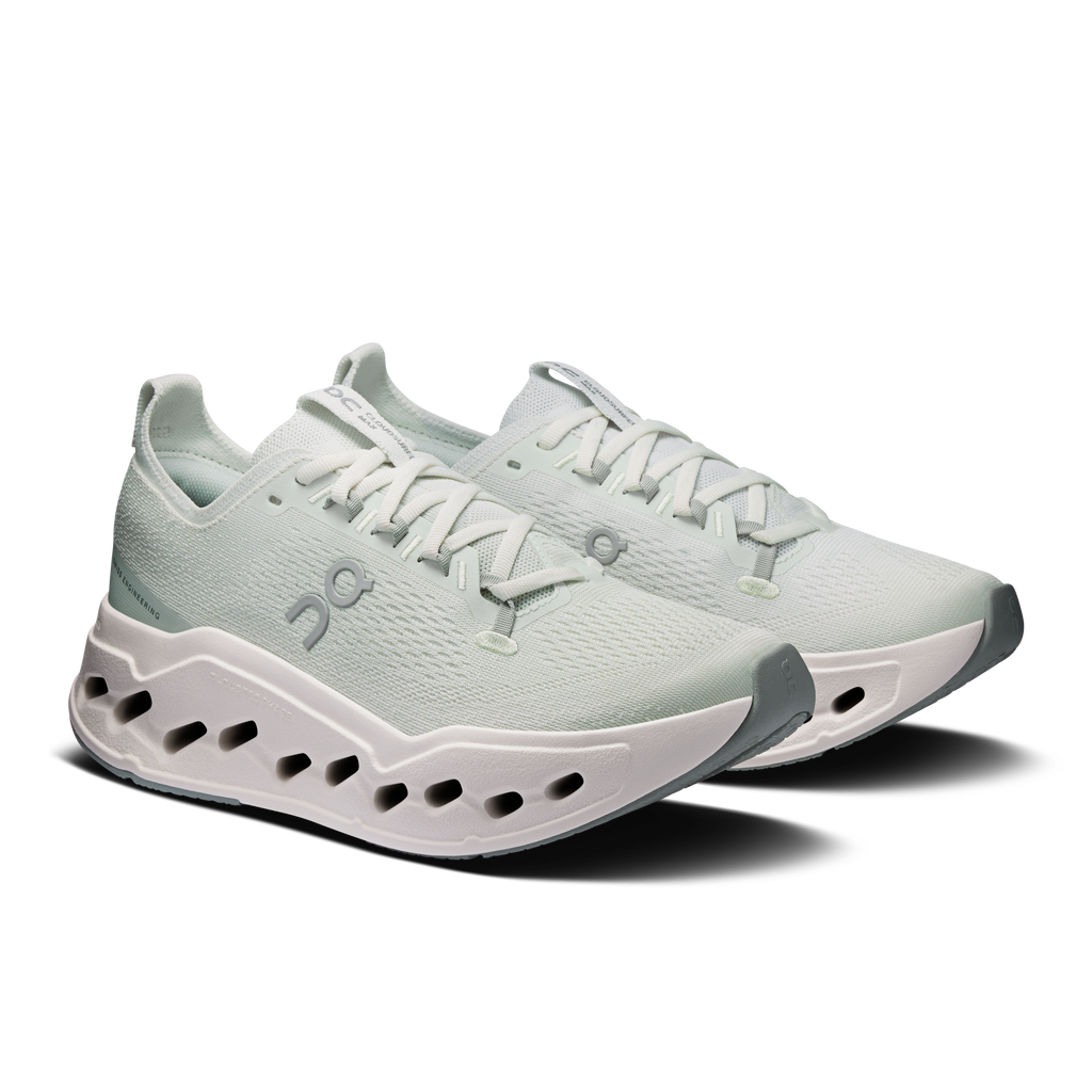 On women's running shoes, light mint knit with white laces and CloudTec pods