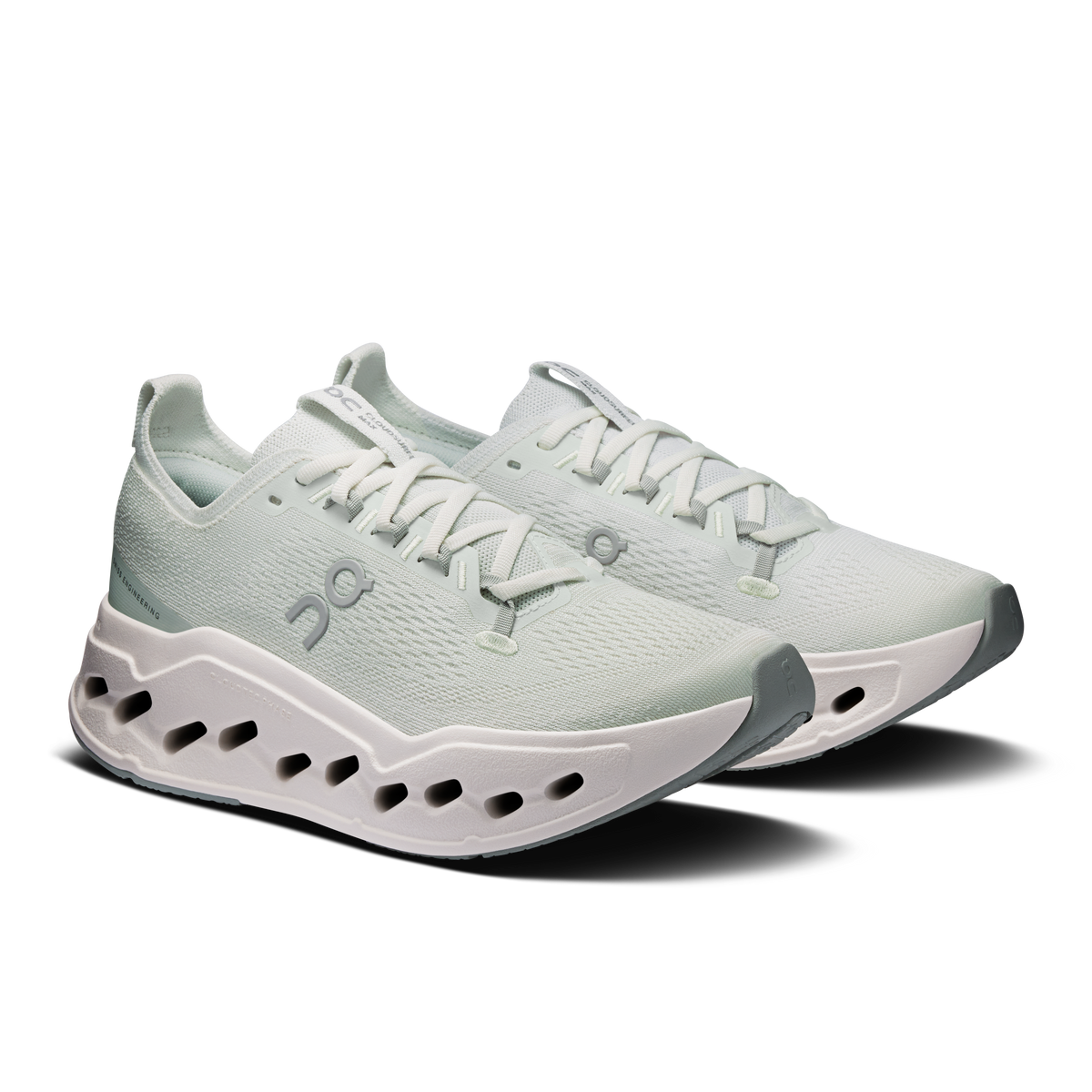 On women's running shoes, light mint knit with white laces and CloudTec pods