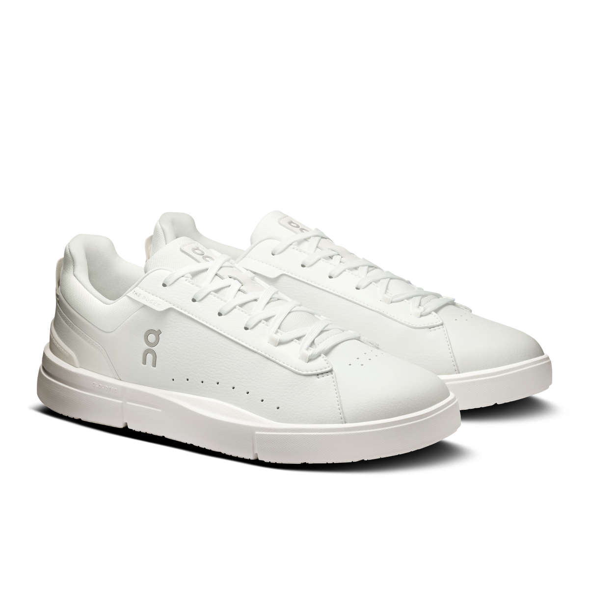 White lace-up sneakers with textured side panel and rubber outsole