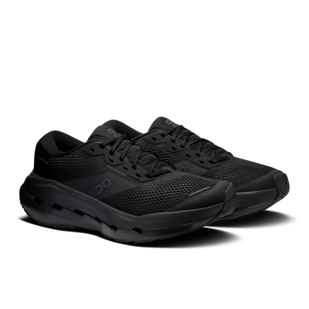 Men's black running shoes, side view showing molded tread sole and lace-up upper