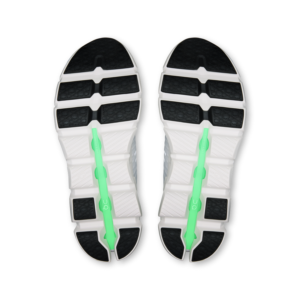 Shoe outsole view: dark tread with white base and green support spine