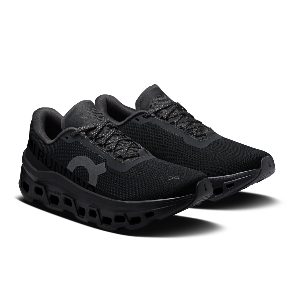 On Cloudmonster 1 women's black running shoes, angled side view with logo detail.