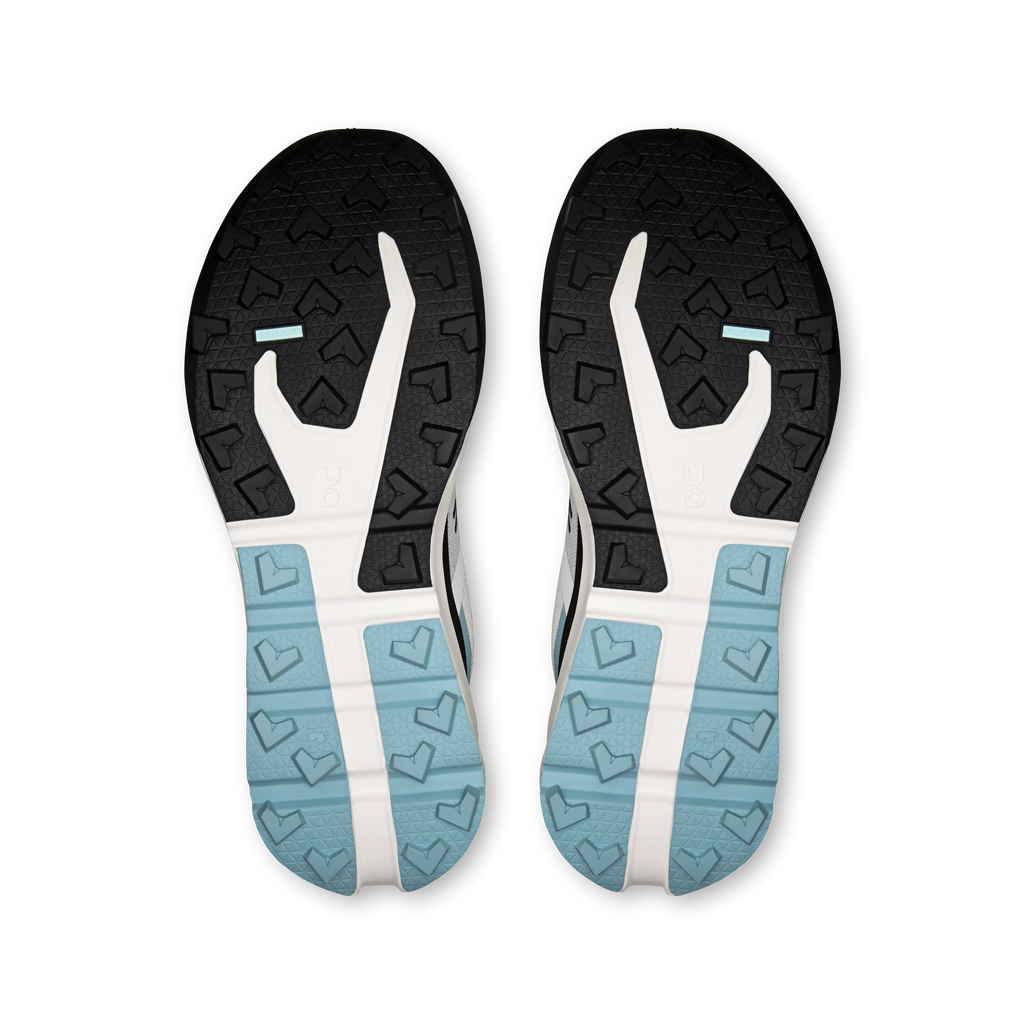 Pair of shoe outsoles with black tread and light-blue grip sections, underside view