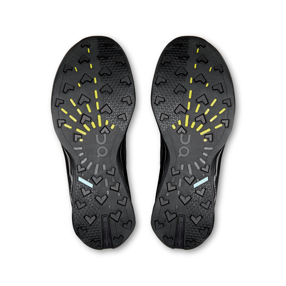 Women's black shoe outsole with patterned tread and bright yellow traction markings