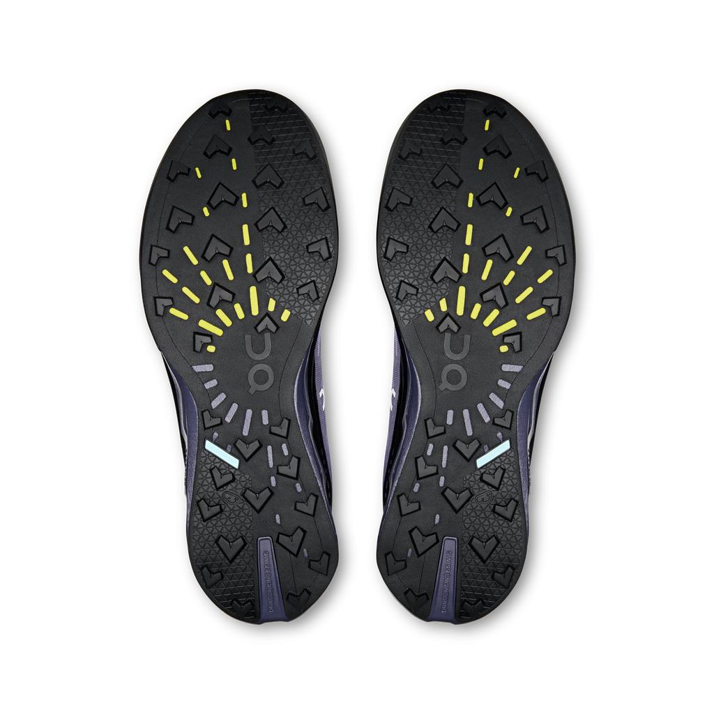 Shoe outsole pair with textured tread, dark rubber with neon yellow traction marks