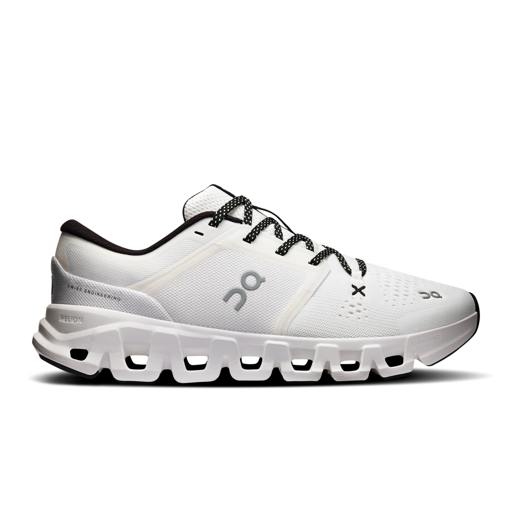 Women's white running shoes with black laces and padded heel collar