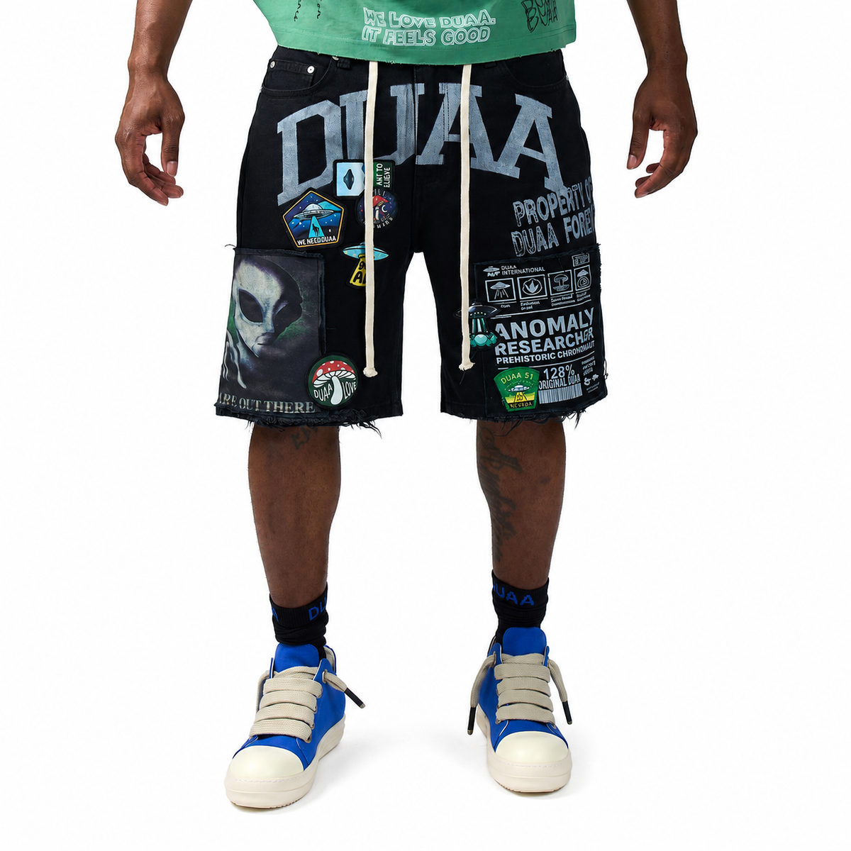 Men’s black graphic utility shorts with distressed hem and patch artwork, UFO print