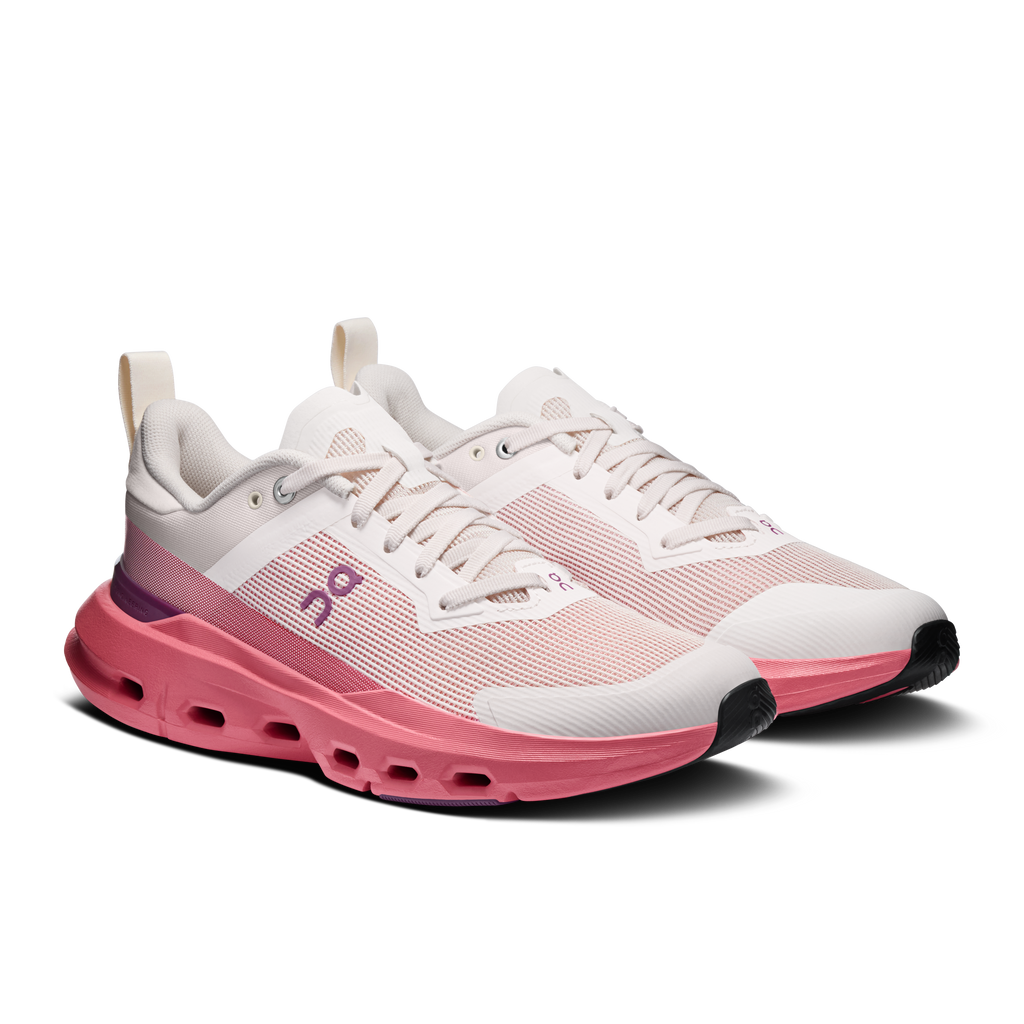 Women's running shoes, white upper with pink knit texture and perforated sole.