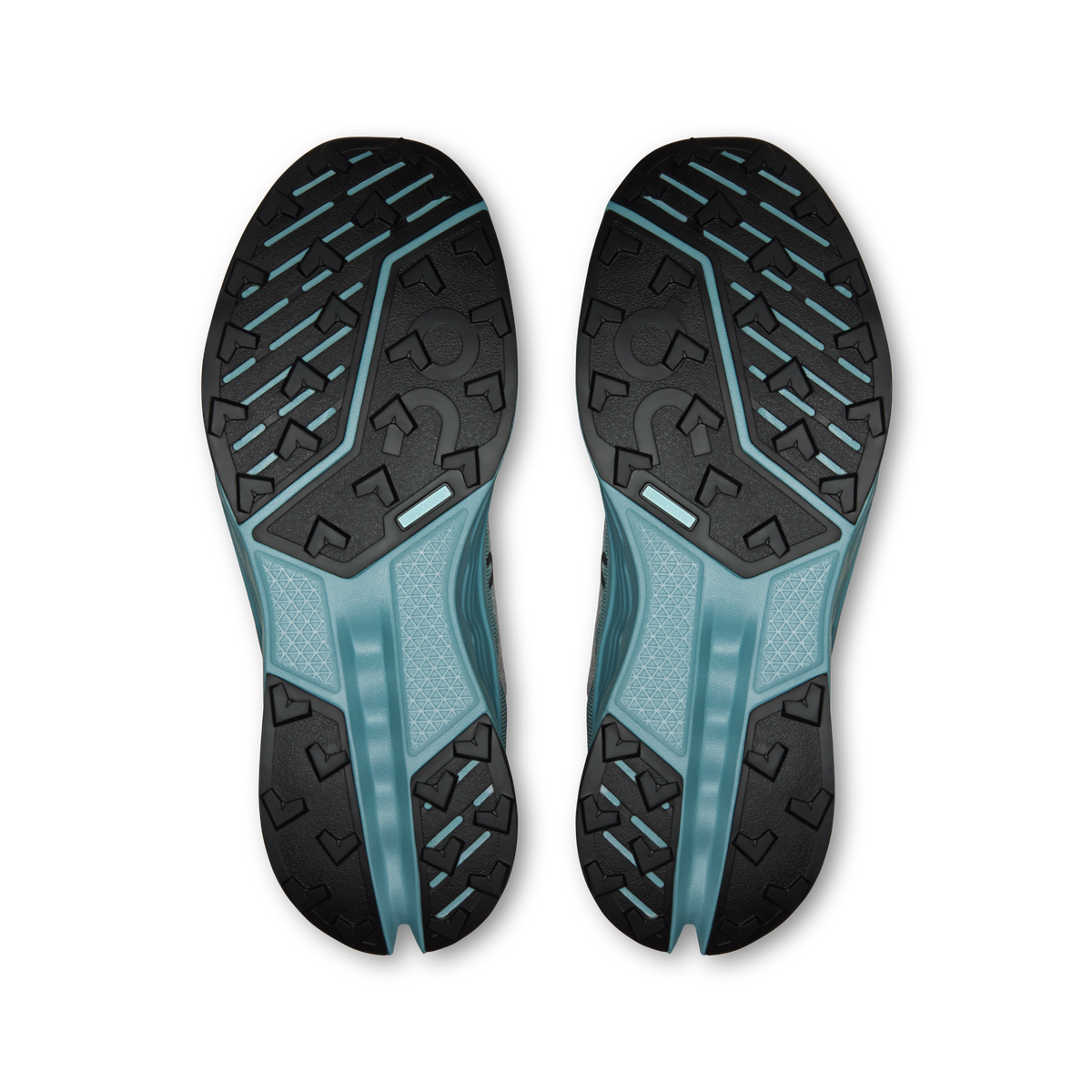 Trail running shoe outsoles with rugged tread and teal rubber forefoot.