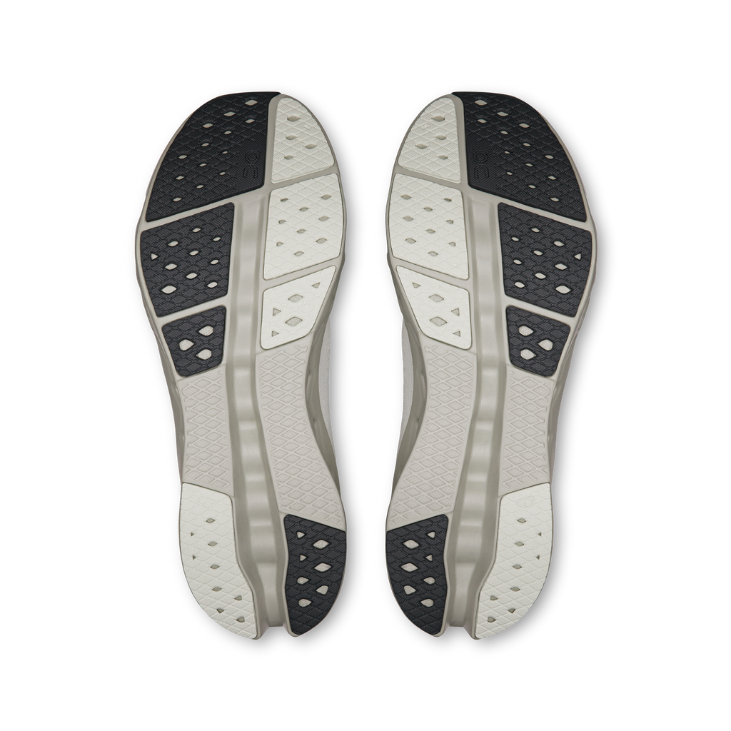 Men's shoe outsoles in light gray with patterned traction pods under heel and forefoot
