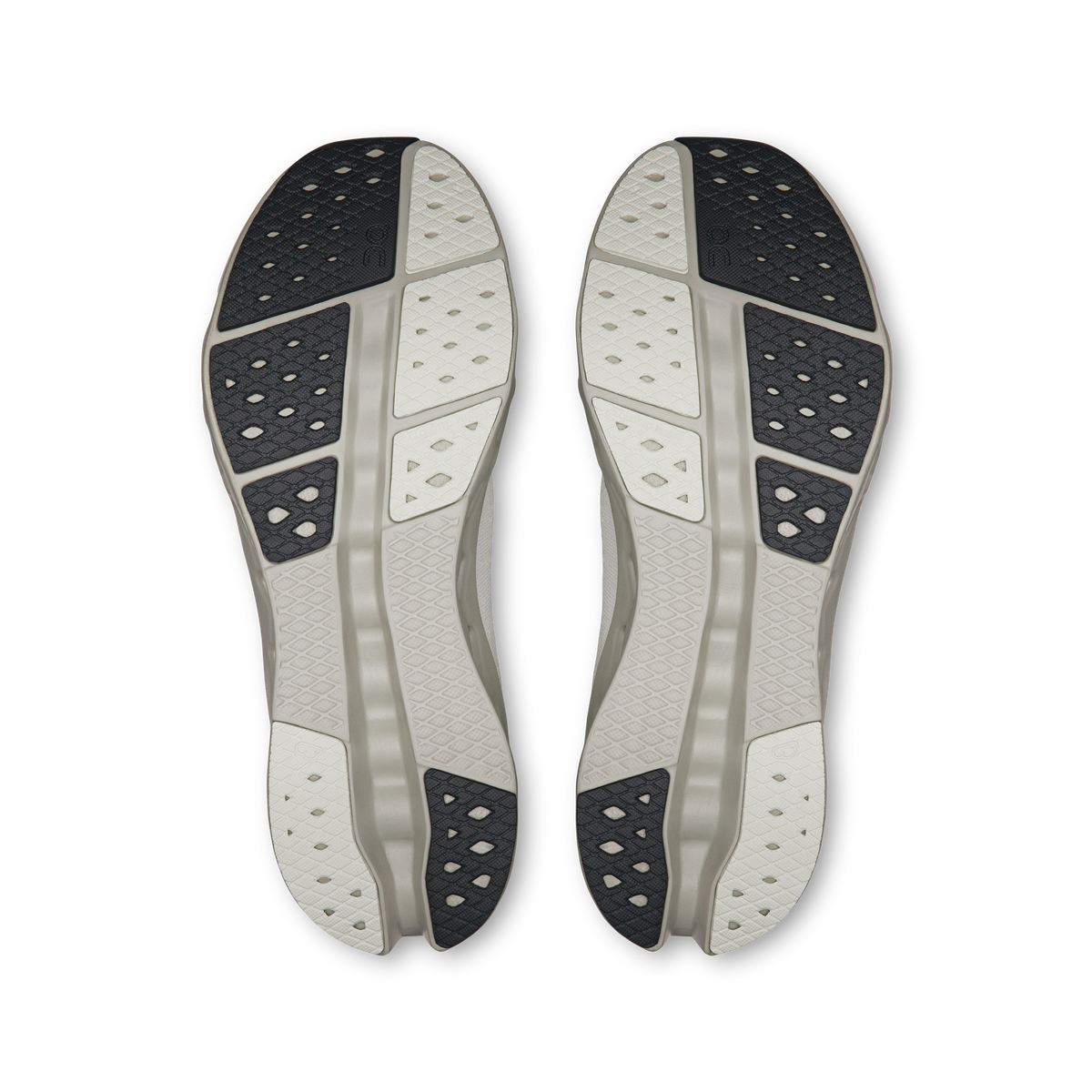 Men's shoe outsoles in light gray with patterned traction pods under heel and forefoot