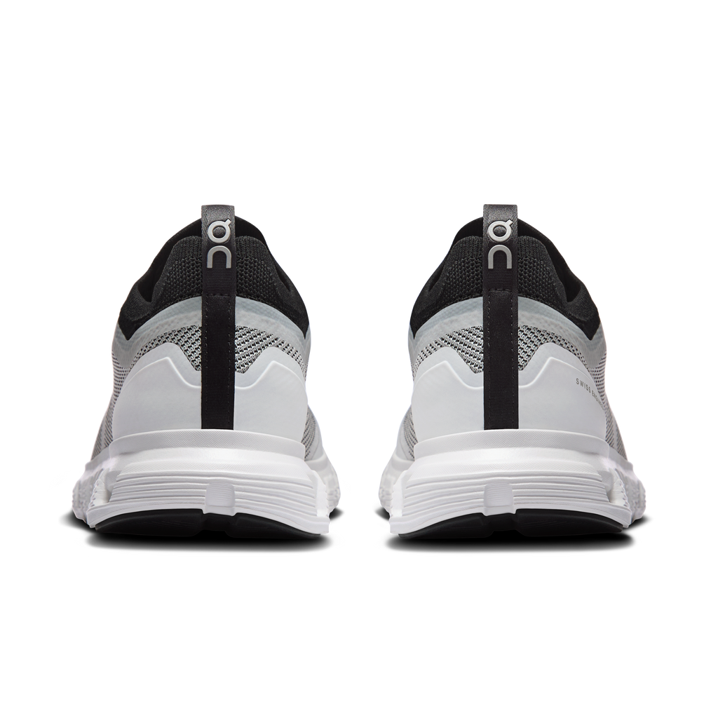 Women’s white/black running sneakers, rear view with pull tab and molded heel
