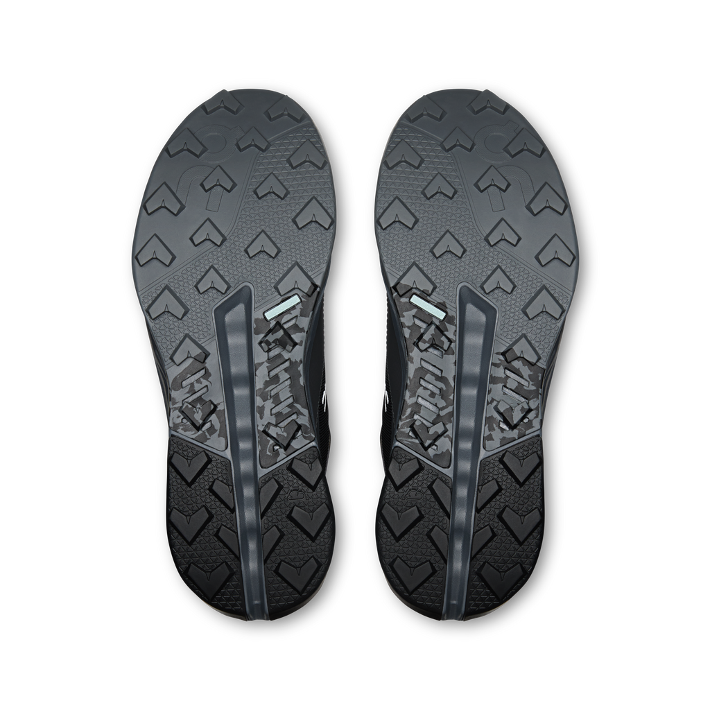 Men's waterproof mid hiking shoe outsoles by On, textured tread with arrow pattern