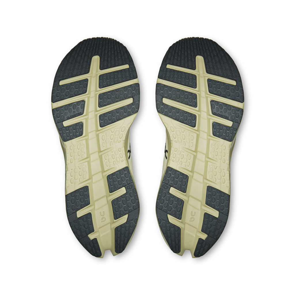 Women's waterproof running shoe outsoles with textured traction tread, dark gray and pale yellow.