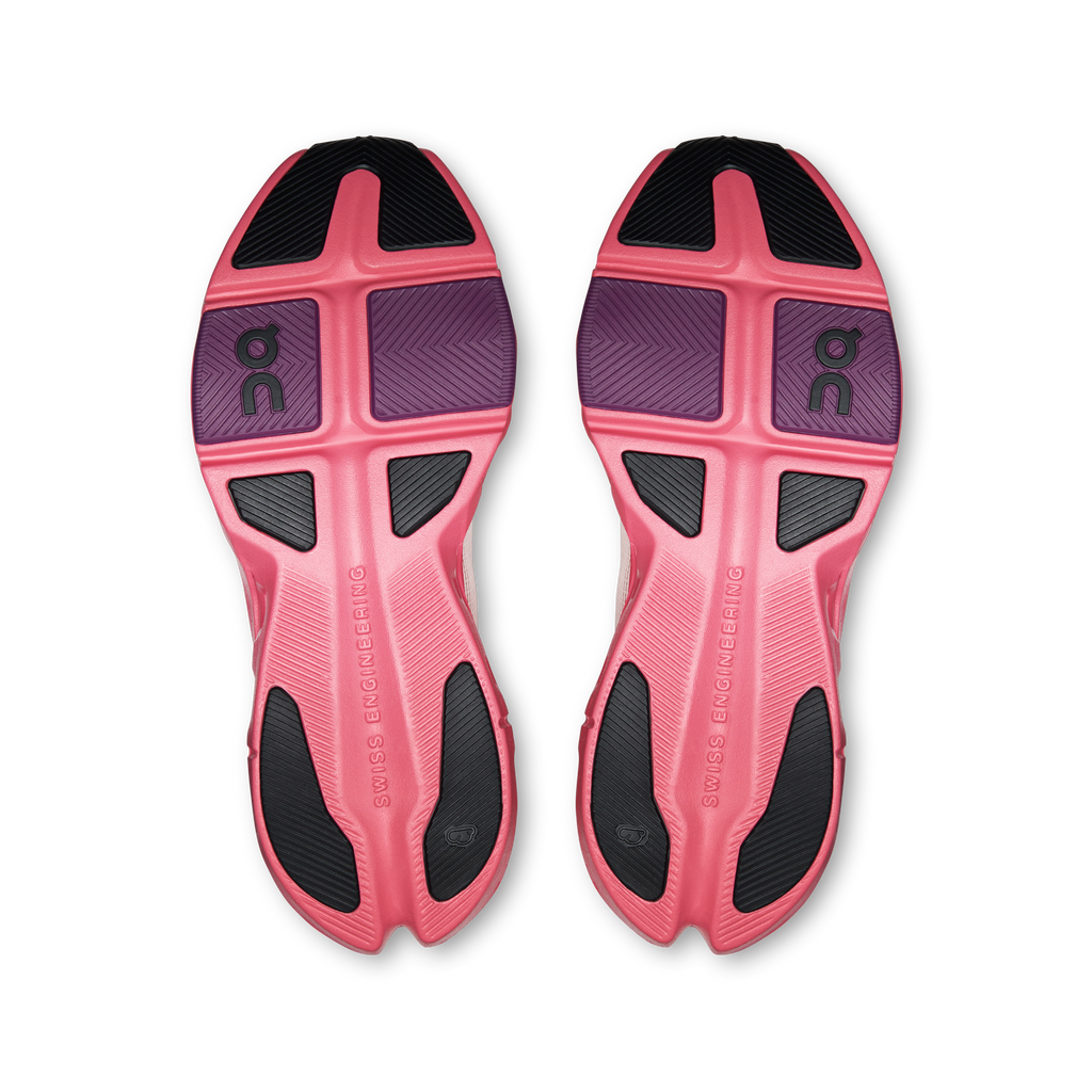 Pair of shoe outsoles, pink and black tread with On logo details.