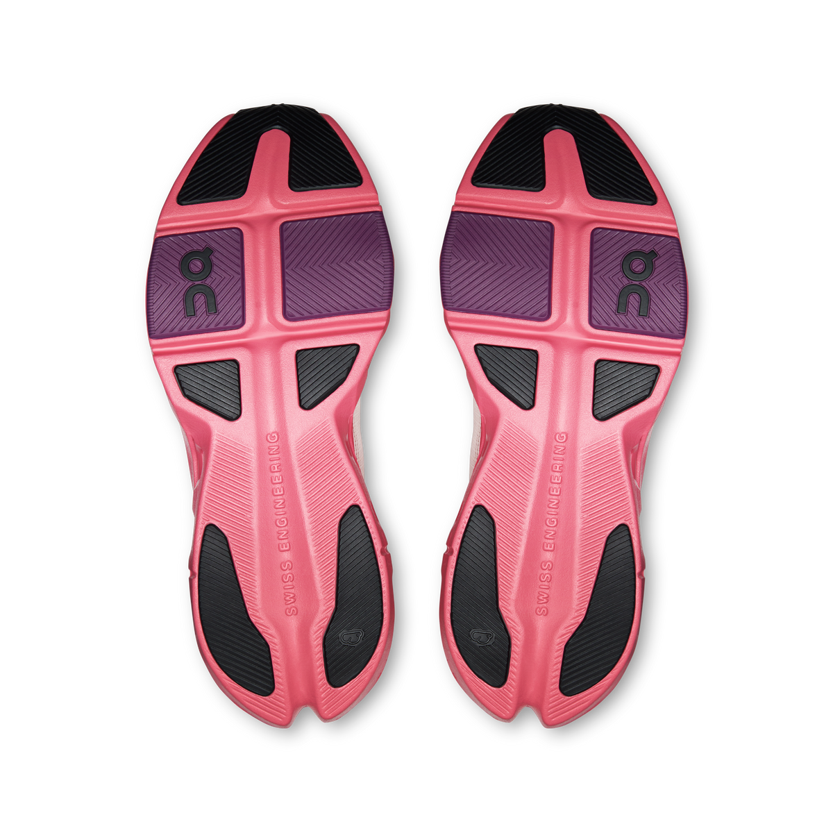 Pair of shoe outsoles, pink and black tread with On logo details.