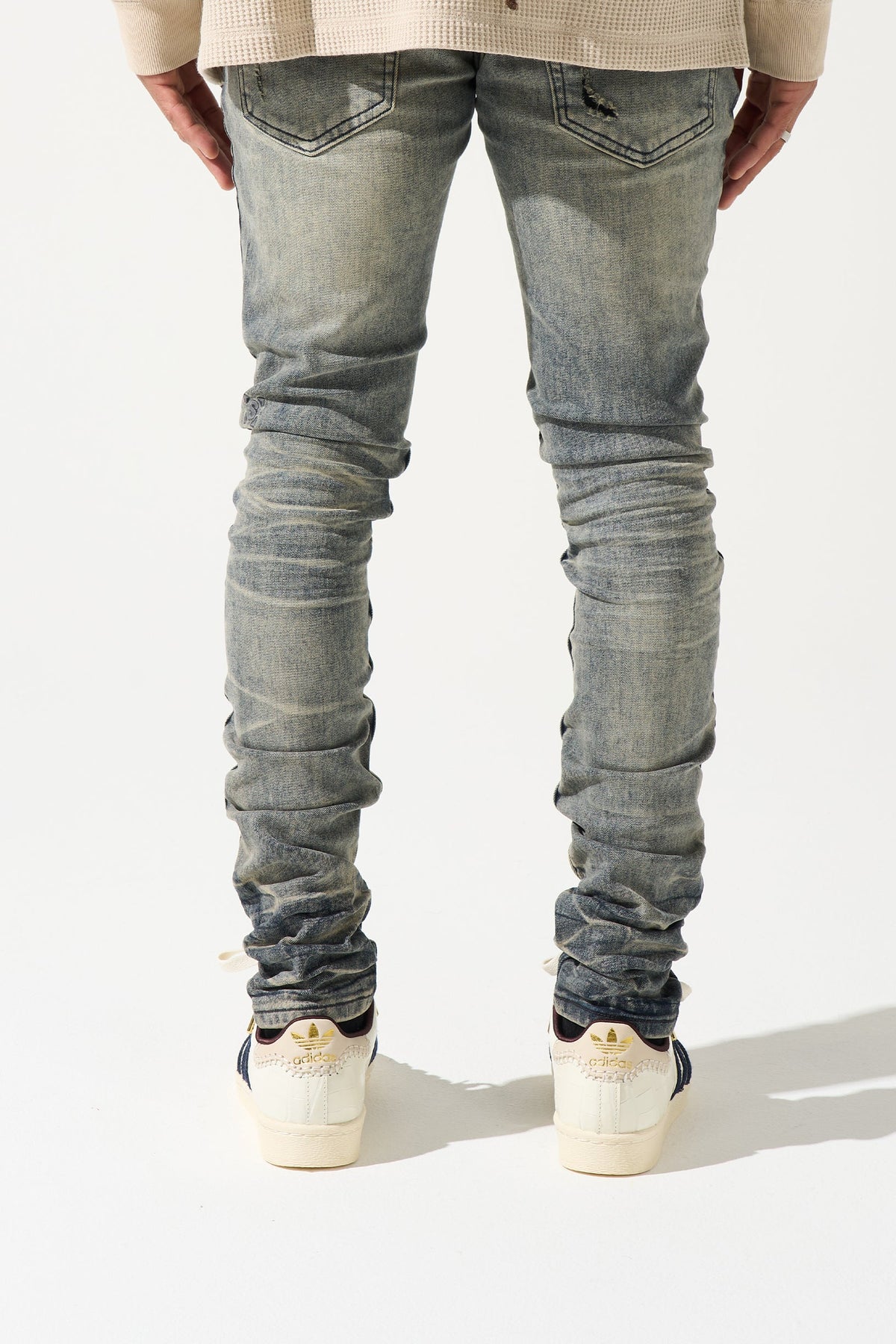 Men's gunmetal-wash slim jeans, back view, stacked fading and ruched ankle cuffs