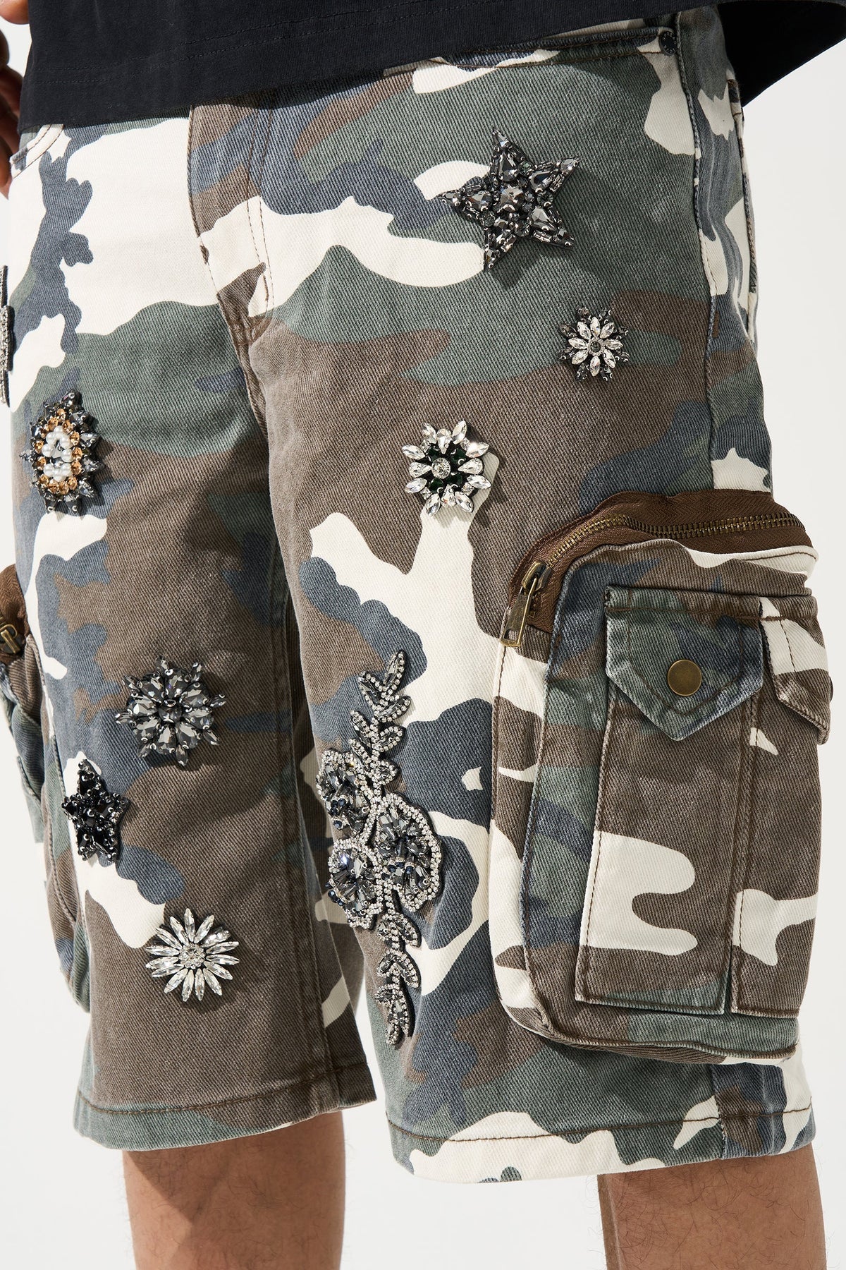 Men's camo cargo shorts close-up with floral patches and side zip cargo pocket